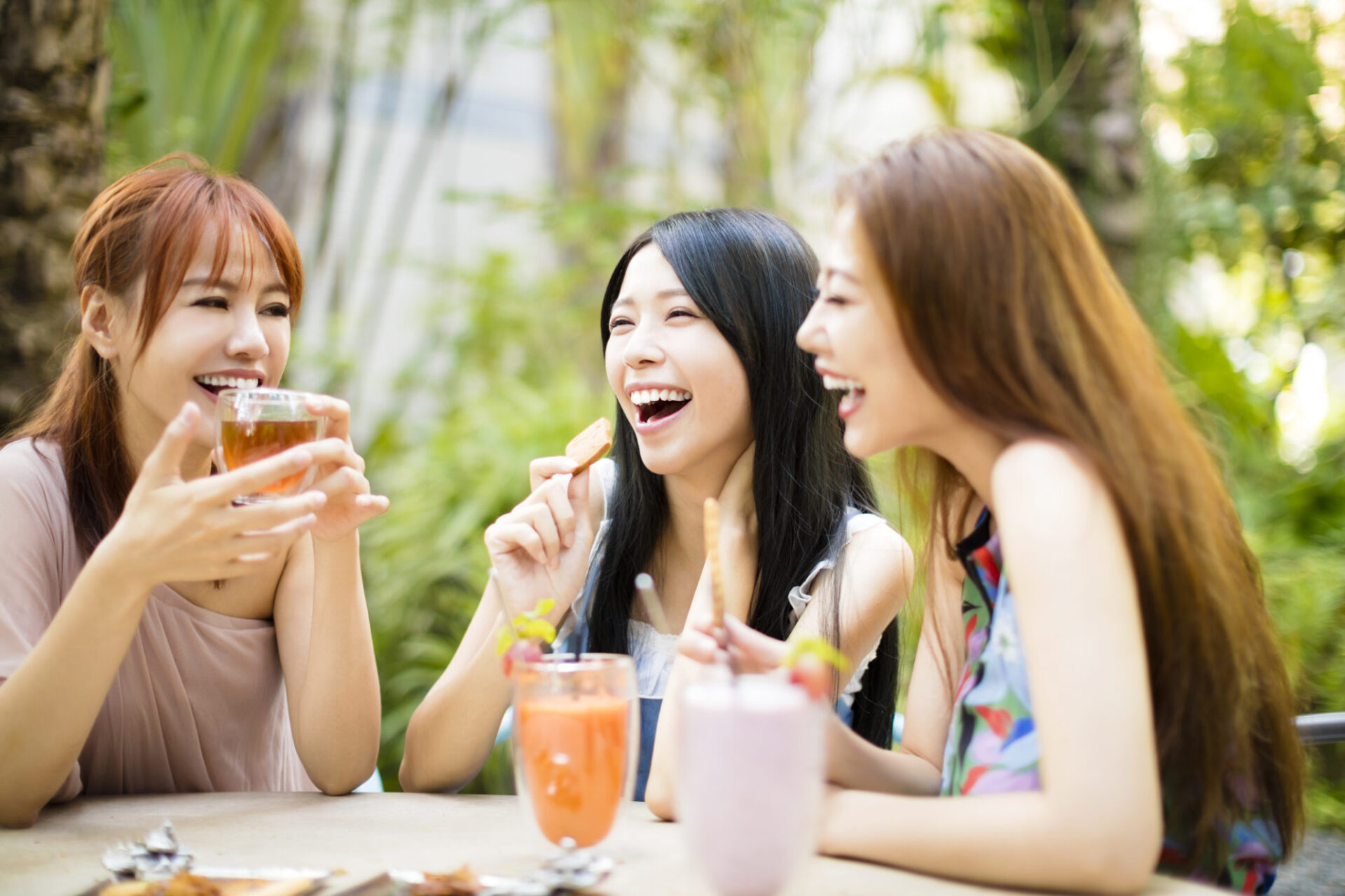 Group Of Female Friends talking In Restaurant garden